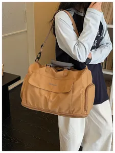 Large capacity travel duffel bag detail view, lightweight canvas gym sports handbag in khaki.