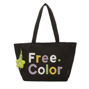 Black canvas tote bag with colorful embroidered text and cute flower pendant accessory.