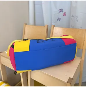 Detail shot of a colorful color block duffel bag, large capacity travel gym bag on wooden chairs.