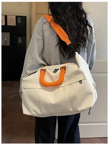 Travel duffle bag large capacity canvas weekender bag with orange handles for gym sports.