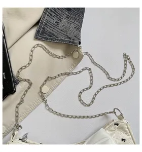 Detailed close-up of a stylish bubble gauze shoulder bag with black bowknot patterns