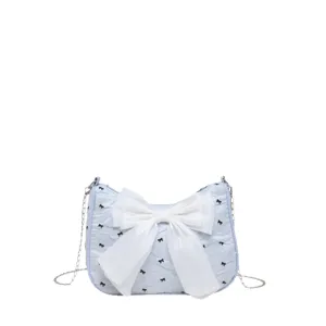 Light blue bubble crepe underarm shoulder bag with large white bow and butterfly patterns