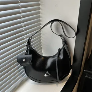 Minimalist black crescent hobo shoulder bag with mini accessory pouch and triangle detail
