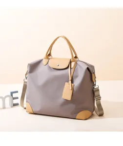 Close-up detail of the stylish casual travel duffel bag featuring durable nylon and leather trim.