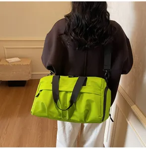 Close-up view of the bright green gym duffel bag showing shoulder strap and side pocket.