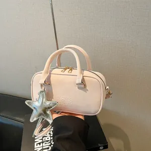 Stylish pink bowling handbag with star charm and crossbody strap for women