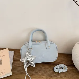 Stylish light blue bowling handbag with star pendant and crossbody strap