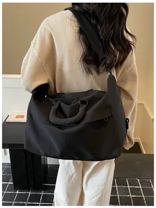 Casual black travel duffel bag for women and men, lightweight gym bag with shoulder strap.