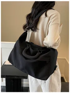 Large capacity black travel duffel bag for women, lightweight gym and weekend overnight bag.