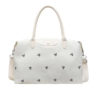 Large capacity travel duffel bag for women, lightweight canvas weekender with cute bow prints.