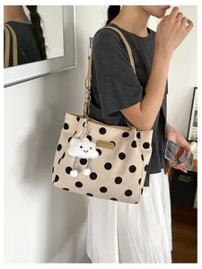 Stylish large capacity polka dot tote bag with cute cloud keychain on female model