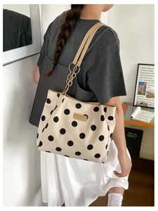 Stylish large capacity cream polka dot tote bag with chain strap detail shown on model