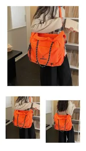 Details of large capacity orange travel shoulder bag with multi pockets and durable straps.