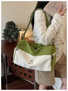 Large capacity green and white canvas travel duffel bag for weekend trips and sports.