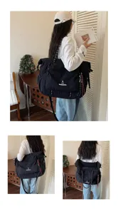 Minimalist Japanese travel bag large capacity lightweight waterproof black duffel bag for sports.