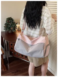 Large capacity duffel travel bag with pink and grey patchwork design, ideal for gym use.