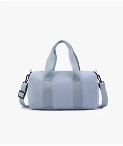 Close-up view of the light blue sports duffel bag showcasing fine fabric and durable straps.