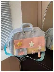 Detail shot of the multi-pocket travel yoga bag with cute star plush charms and color block.