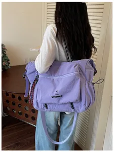 Large capacity purple canvas travel shoulder bag for short trips and daily casual use.