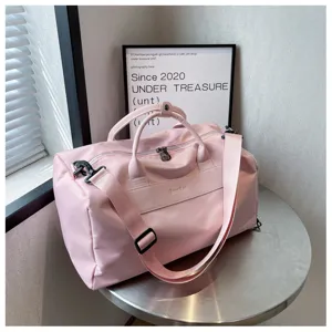 Pink travel duffel bag detail, large capacity gym bag with wet dry separation and adjustable strap.
