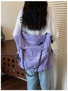 Large capacity purple canvas shoulder travel bag, casual daily wear lifestyle product detail.