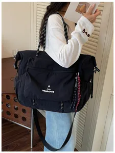 Minimalist black travel duffel bag with large capacity, durable fabric and multiple pockets.
