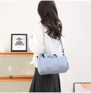Light blue cylindrical sports gym bag, waterproof minimalist design for daily fitness.