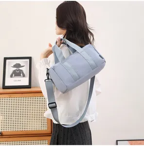Minimalist waterproof small sports gym duffel bag for short travel and yoga, light blue detail.