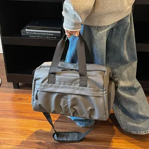 Large capacity travel duffel bag gym bag with shoe compartment and shoulder strap.
