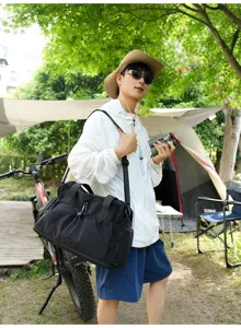 Large capacity black travel duffel bag for camping, fitness and short trips with shoulder strap.