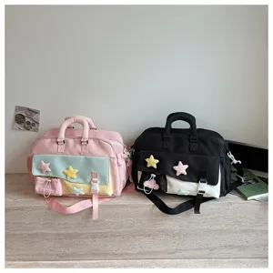 Stylish dual-color gym duffel bag detail with cute plush star patches for travel workouts.