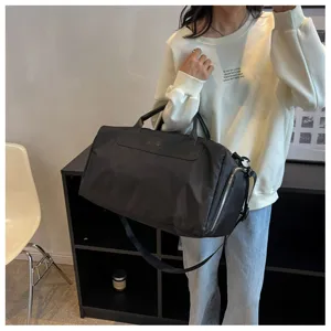 Large capacity black travel duffel bag with shoe compartment and wet dry separation for gym.