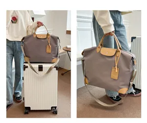 Stylish casual travel duffel bag with durable nylon material and brown leather trim details.
