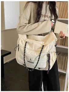 Detail scene of a large capacity Japanese style casual canvas travel crossbody bag.