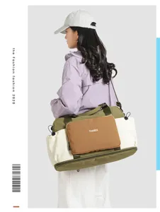 Detailed view of the color-block nylon travel duffel bag showing its functional side pocket.