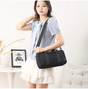 Small black gym duffel bag, waterproof cylinder sports shoulder bag for fitness and short trips.