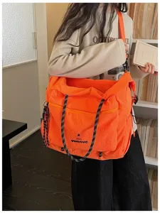 Large capacity orange canvas shoulder bag casual travel messenger bag with multi pockets.