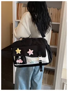 Black and white large capacity travel bag detail, featuring cute plush star patches.