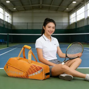 Large capacity sports bag for tennis and badminton, stylish orange tote and shoulder design.