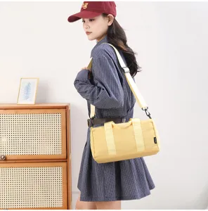 Small yellow cylinder sports fitness bag, waterproof casual crossbody luggage bag for daily use.