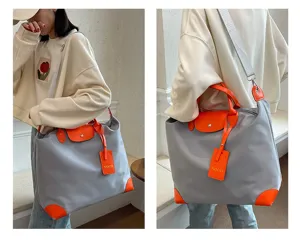 Stylish grey and orange casual travel tote bag with shoulder strap and stylish handle design for daily use.