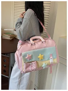 Detailed view of the cute pastel duffel gym bag with colorful plush stars and shoulder strap.