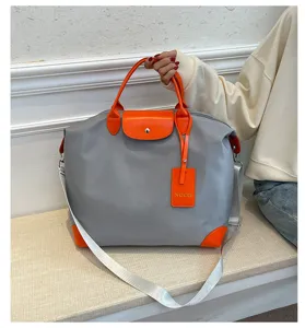 Nylon travel handbag with orange leather trim, spacious casual shoulder bag for daily use.