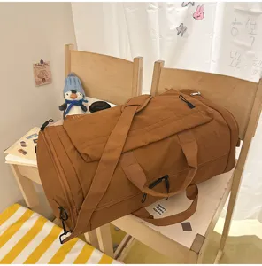 Large capacity travel duffel bag for gym, sports, and short trips in warm brown color.