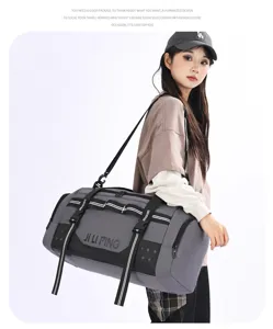 Detailed view of large capacity gray travel duffel bag showcasing functional storage design.