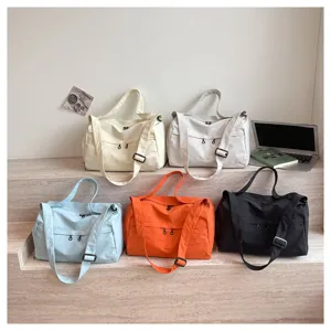 Multi-color canvas travel duffel bag with adjustable strap, large capacity daily use.