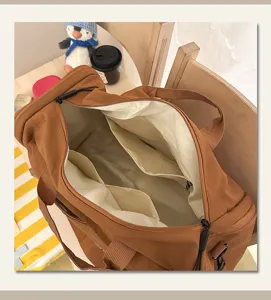 Interior detail view of the large capacity brown travel duffel bag with multi-compartments