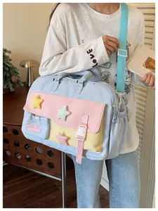 Detail view of the multi-pocket pastel travel yoga bag with cute star charms and dual straps.