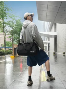 Water-resistant large capacity travel duffel bag with shoulder strap for short trips.