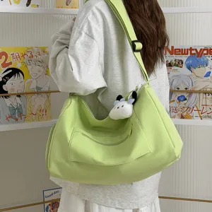 Light green large capacity canvas shoulder bag casual travel crossbody hobo bag with cute charm.